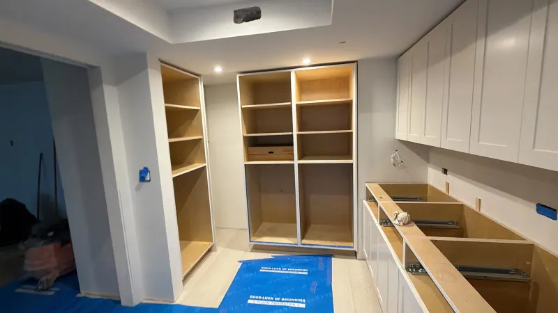 Kitchen cabinets being installed over floor protection
